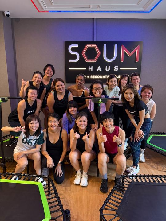 A group photo under the SOUM HAUS sign
