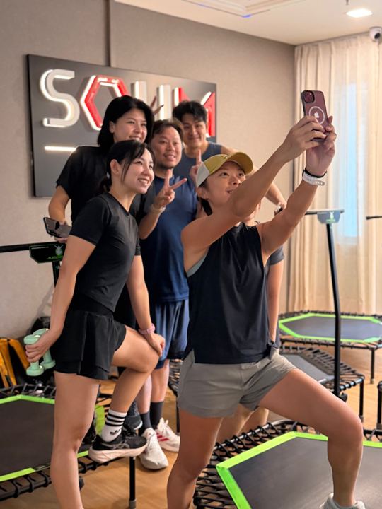 A selfie under the SOUM sign after class