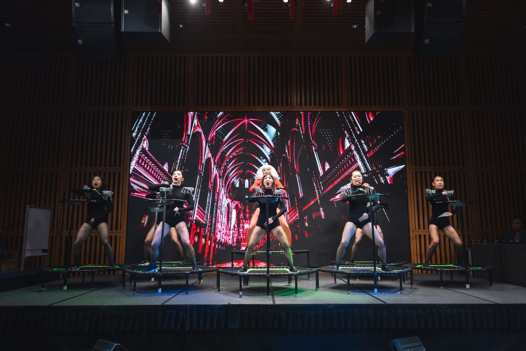 Five instructors mid-routine on the main stage