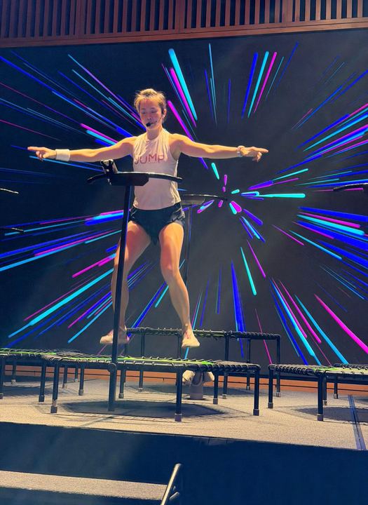 An instructor leading from the stage, arms wide
