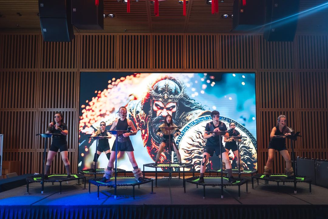 A routine on stage against the warrior screen